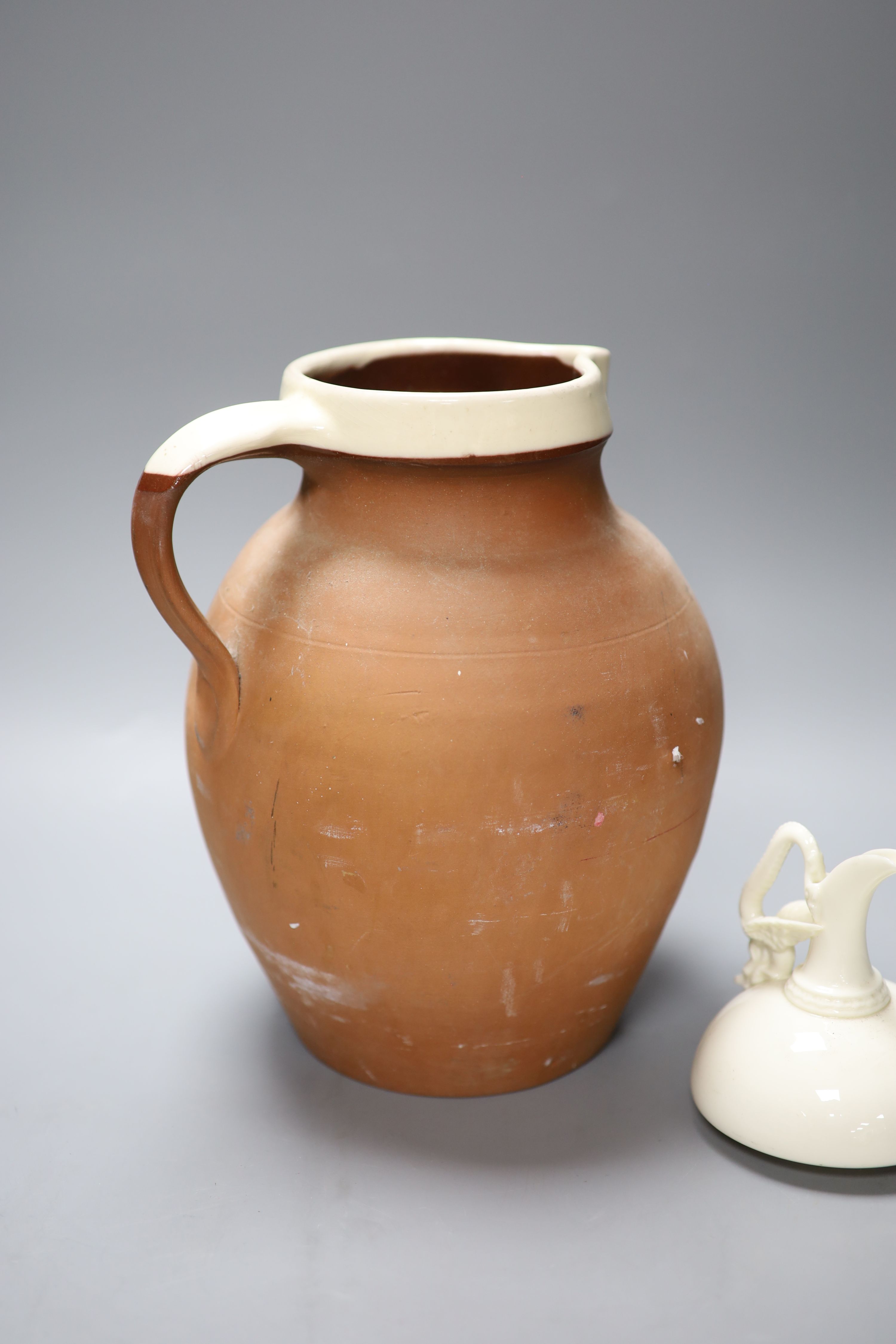 An ornate 19th century jug, another and a cream glazed Worcester jug, tallest 29cm